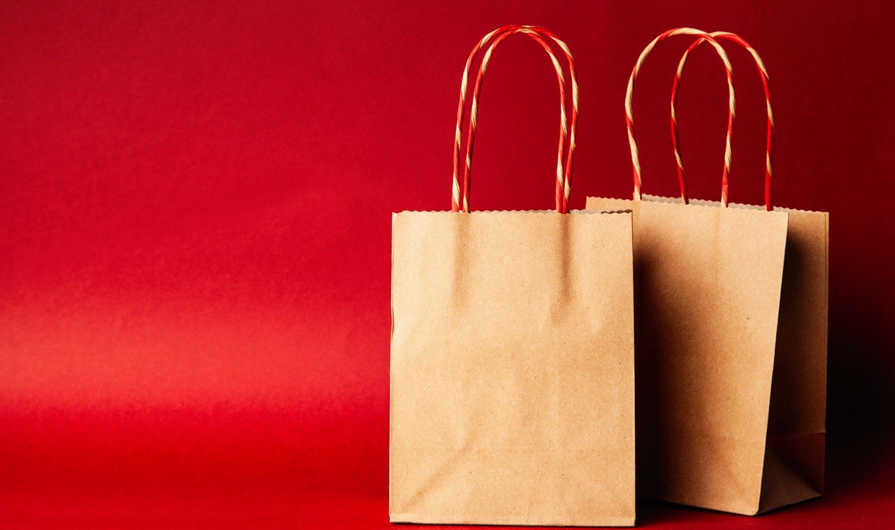brown paper shopping bags against a red background