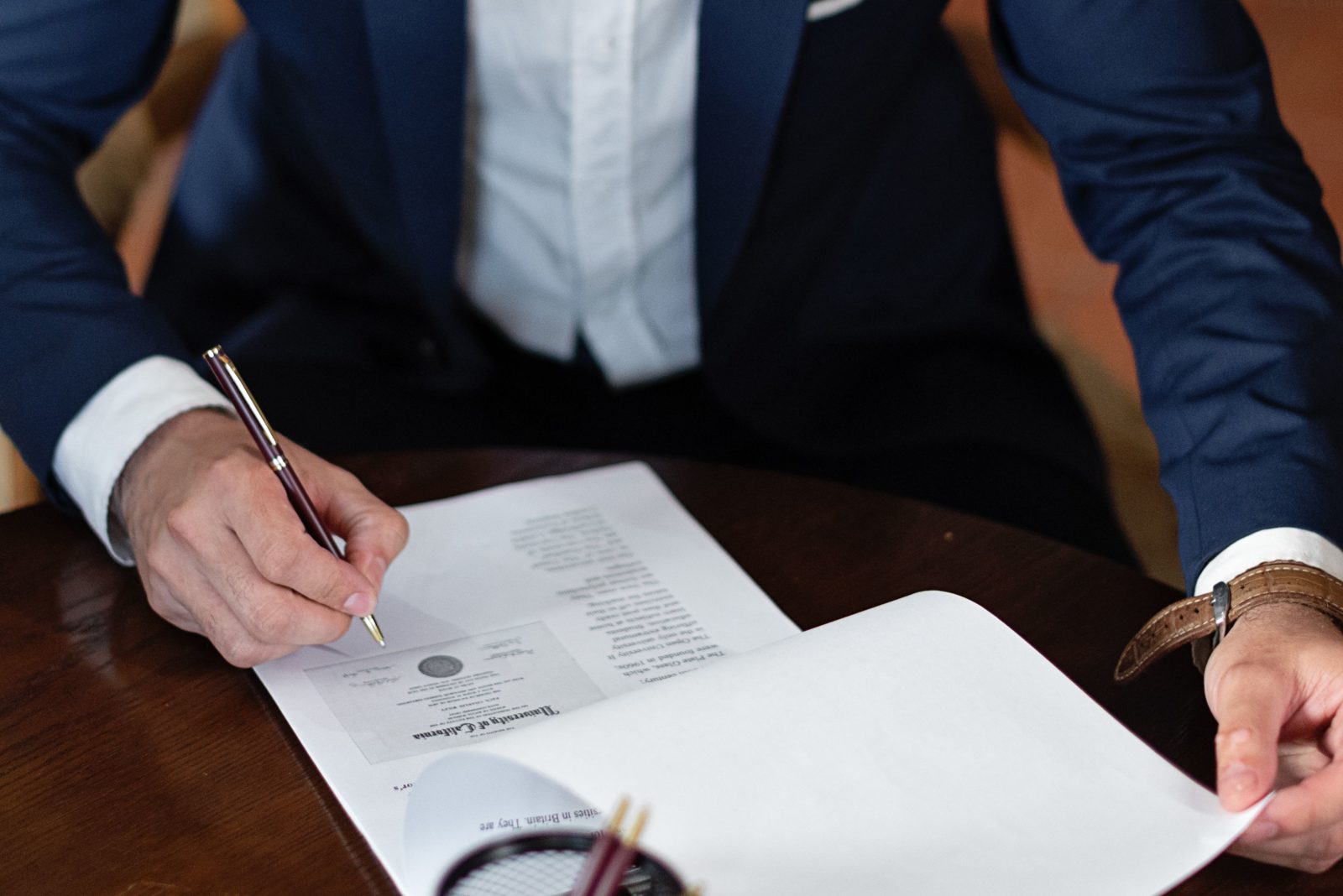 man signing a contract